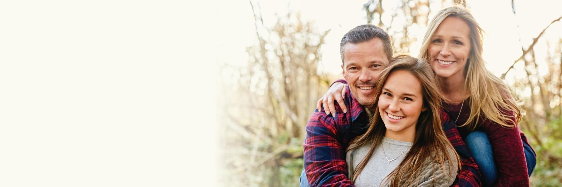 Mother, father, and daughter smiling | Dentist Paddington NSW